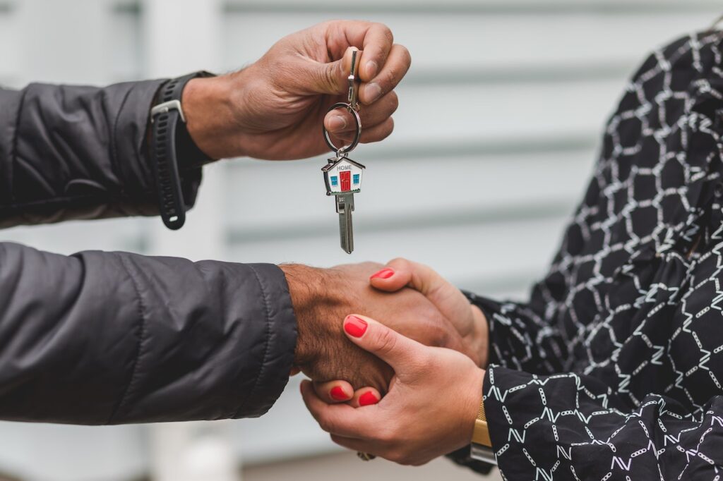 A person receiving keys to a house they bought